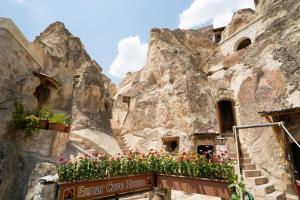 a group of stairs with flowers in front of a mountain at Cappadocia Ennar Cave Swimming Pool Hot & SPA in Nevsehir