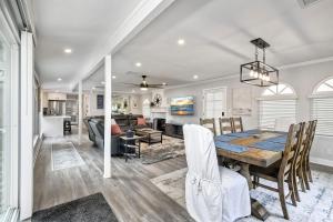 a dining room and living room with a table and chairs at Steps to Beach, 2BR Dog Friendly Home with Fire Pit in Carlsbad