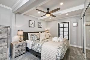 a bedroom with a bed and a ceiling fan at Luxury Beach Duplex, Sleeps 9, Dog-Friendly, AC, Fire Pit & Grill in Carlsbad
