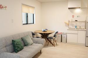 a living room with a couch and a table at Bamboo Retreat Tofuku in Kyoto