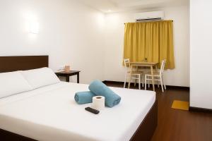 a bedroom with a bed and a table with a chair at Vincent Resort Hotel in Angeles +29 photos