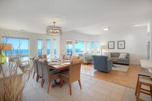 a dining room and living room with a table and chairs at Exclusive Beachfront Duplex in Carlsbad Village Ocean Views, Sleeps 9 in Carlsbad