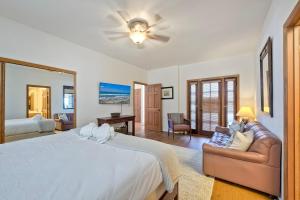 a bedroom with a large bed and a couch at Exclusive Beachfront Duplex in Carlsbad Village Ocean Views, Sleeps 9 in Carlsbad