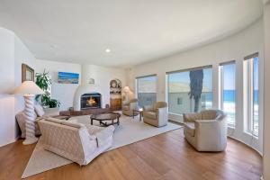 a living room filled with furniture and a fireplace at Exclusive Beachfront Duplex in Carlsbad Village Ocean Views, Sleeps 9 in Carlsbad