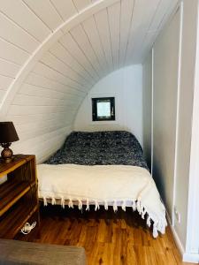 a bedroom with a bed in an attic at Welcome to La Petite Ferme & Family in Carracastle