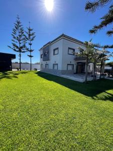 a white building with the sun in the sky at Villa Royale Prestige Safaa in Dar Bouazza