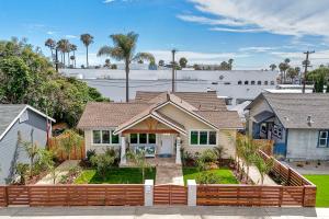 a house with a fence in front of it at Monarch Estate, Luxe Studio with AC , Walk to Beach, Pier & Dining in Oceanside +7 photos