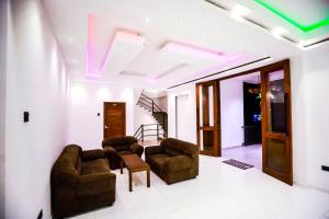 a living room with couches and chairs and a ceiling at Kudila Resort in Anuradhapura
