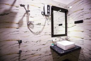 a bathroom with a sink and a shower at Kudila Resort in Anuradhapura +85 photos