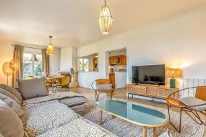 a living room with a couch and a table at L'abeliano - House With Pool Near Uzs in Connaux