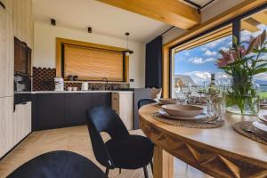 a kitchen and dining room with a table and chairs at Tatrzański Horyzont in Biały Dunajec +90 photos