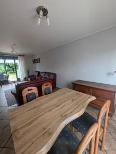 a dining room with a wooden table and chairs at Ferienhaus Thomm in Konz