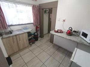 a kitchen with a sink and a counter top at Sleep@161 Benade Drive in Bloemfontein