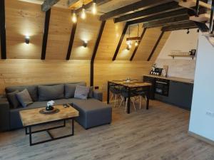 a living room with a couch and a table at Brvnara Tarski proplanak in Kaludjerske Bare