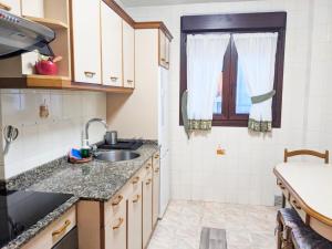 a small kitchen with a sink and a window at Candás Suites in Candás