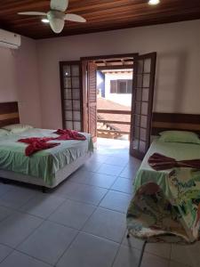 Ένα ή περισσότερα κρεβάτια σε δωμάτιο στο Casa Bem te vi Colibri +31 φωτογραφίες