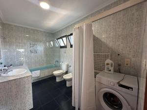 a bathroom with a washer and a washing machine at Villa Portalmar in Benicarló +102 photos