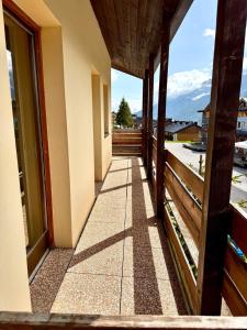 a hallway of a house with a view of a balcony at Top Residence Bilocale Abete in Passo del Tonale