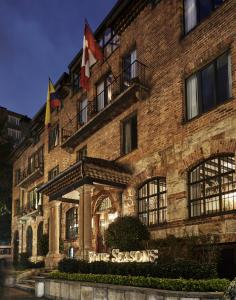 a building with the seasons hotel at night at Four Seasons Hotel Casa Medina Bogota in Bogotá