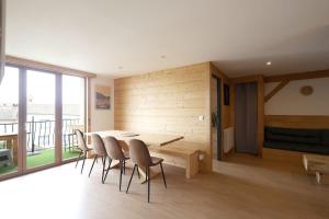 una sala da pranzo con tavolo e sedie di Le Hibou - Grand Appartement, Vue Montagne a Les Angles