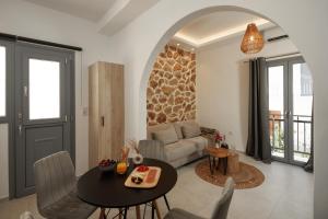 a living room with a table and a couch at CasaNova Luxury Apartment in Naxos Chora