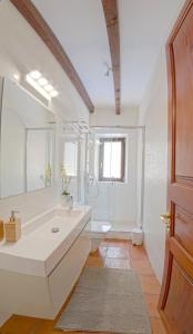a white bathroom with a sink and a toilet at Mallorca Villa 1463: Relax in Your Private Oasis in Deia