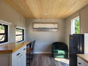 a kitchen in a tiny house with a refrigerator at Gibsons Creek RV Resort and Campground in Gibsons