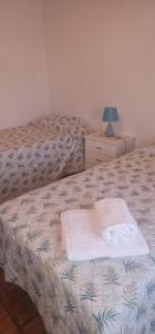 a bedroom with two beds and a lamp on a night stand at Cantinho Alentejano-Rua das Hortas, Corte Pao e Agua in Mértola +6 photos