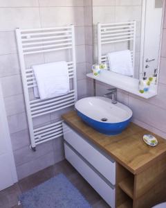 a bathroom with a sink and a mirror at Pensiunea Casa Lola in Bontida