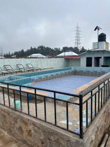 a swimming pool on top of a building at Sylwan-O Sunrise Homestay And Restaurant in Shillong +21 photos