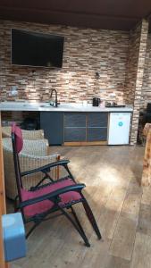 a chair in front of a kitchen with a tv at Oasis rural in Benidorm in Benidorm