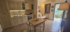 a kitchen with a small table and a kitchen with a couch at Colle Bellavista in Ripi