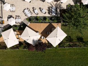 an aerial view of a house with white umbrellas at Familotel Kindl in Neustift im Stubaital