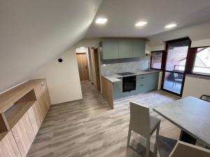a kitchen with a table and a dining room at Apartmány PEKÁR in Silica