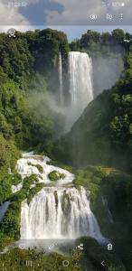 a waterfall in the middle of a river at La Terrazza sul Velino in Le Marmore