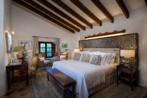a bedroom with a large white bed and a table at Elegant Villa Retreat in Banyalbufar, 1022 in Banyalbufar