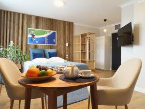 a room with a bed and a table with fruit on it at Apartament Studio 220 in Biała Podlaska
