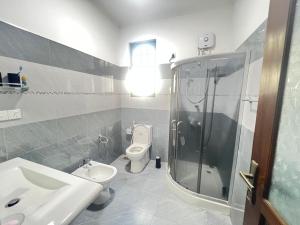 a bathroom with a shower and a toilet and a sink at Villa J&T in Katunayake +11 photos