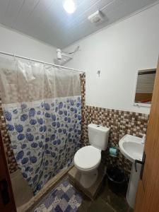 a bathroom with a toilet and a sink at Hotel da Vila in Nova Friburgo +9 photos