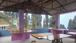 a room with tables and a view of a mountain at Chandani Homestay in Lava