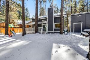 a house in the snow with a playground at Moose-in' Around ~ Walk to Slopes Mountain Home with Private Hot Tub, Ski Locker & Playground in Big Bear Lake