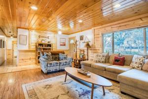a living room with a couch and a table at Entertainment Cabin ~ Lovely home with hot tub, game room, balcony, & firepit - dog friendly in Sugarloaf