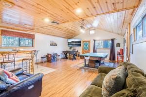 a living room with a couch and a ping pong table at Entertainment Cabin ~ Lovely home with hot tub, game room, balcony, & firepit - dog friendly in Sugarloaf