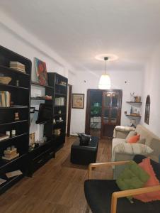 a living room with a couch and a chair at Coastal Elegance in Oulad Akkou