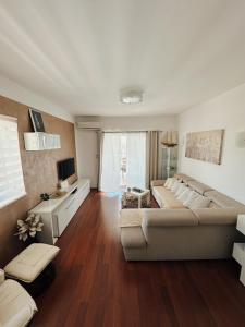 a living room with a couch and a table at Stunning Gold apartment with pool in Solin