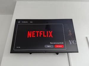 a tv screen with the netflix sign on it at Long Term Comfort - 2BR Haven in Cheshunt