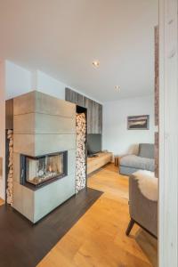 a living room with a fireplace and a couch at Riverside Chalet Dreitorspitz in Garmisch-Partenkirchen