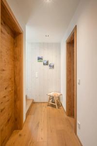 a room with a wooden floor and a wooden stool at Riverside Chalet Dreitorspitz in Garmisch-Partenkirchen