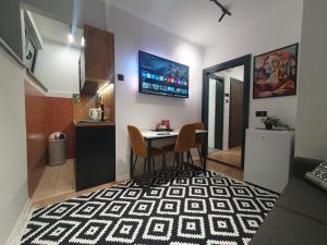 a small dining room with a table and two chairs at Sofia Apartment free parking in Sarajevo
