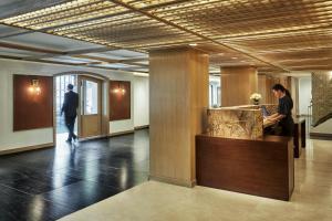 a lobby with two people standing at a counter at Four Seasons Hotel Bogota in Bogotá